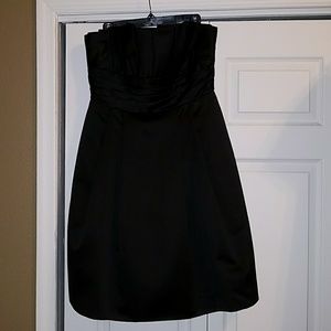 Black cocktail dress. Fit and flare style.